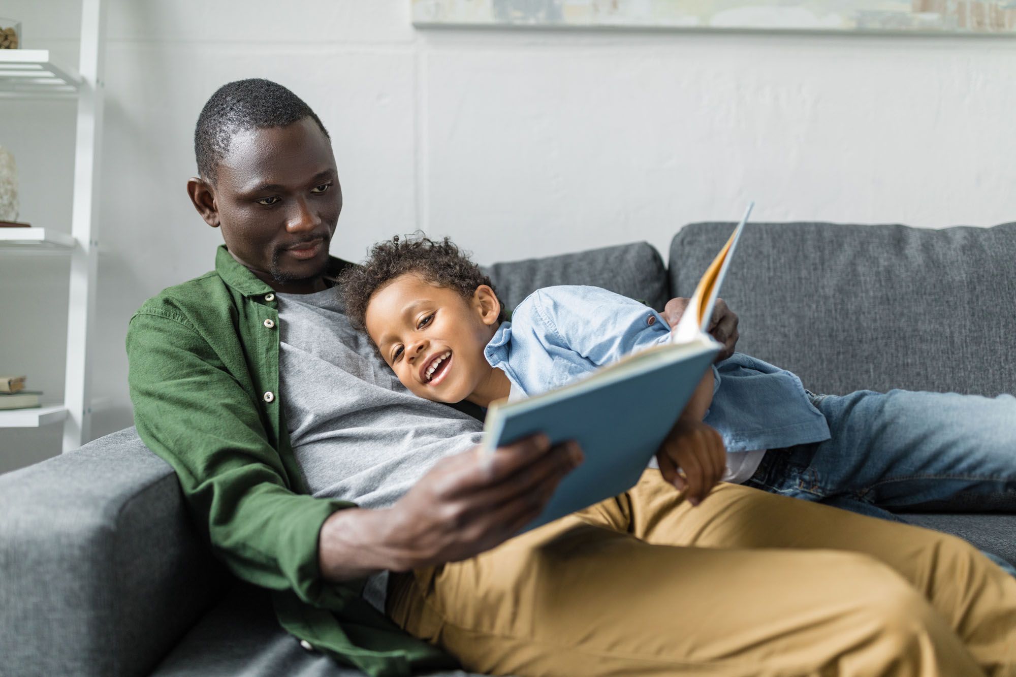 Father reading to his smiling son